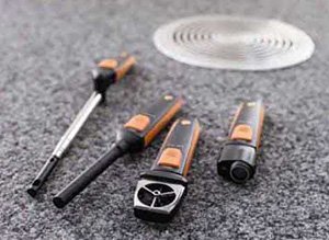 Testo VAC Set layed on the ground near a drain